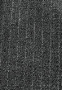 Gray fabric with a textured finish, featuring subtle vertical stripes and a soft, woven appearance.