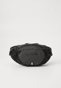 Black and gray fanny pack with a grid pattern, adjustable straps, two zippered compartments, and a brand logo on the front.