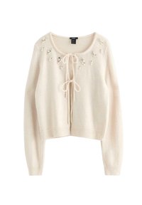 Maglione corto beige chiaro in materiale morbido, con scollo rotondo, chiusura frontale a fiocco e decorazioni con perline sulle spalle.