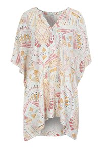 Lös passform, kortärmad tunika i vit tyg med färgglada geometriska mönster i rött, gult och grönt. V-ringad design, krökt nederkant.