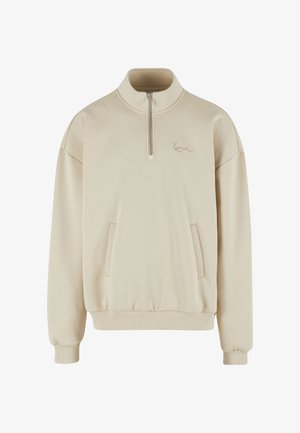 Beež värvi pika varrukaga pullover, millel on pool-zipp krae, esimesed taskud ja soonilised varrukaotsad. Pehme kangas, millel on rindkere peal õrn logo detail.