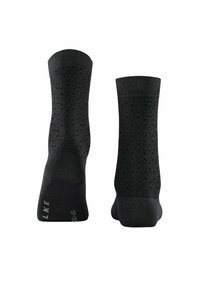 Schwarze Socken mit einem strukturierten geometrischen Muster, glatter Oberfläche und verstärkten Zehen- und Fersenbereichen. Gedrucktes Logo auf der Sohle.