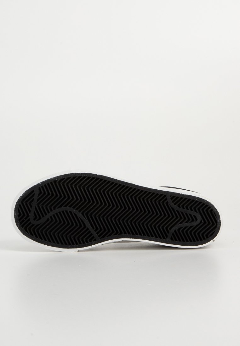 Suela de goma negra con patrón de espiga, borde blanco y diseño minimalista. Forma plana y redondeada, adecuada para calzado casual.