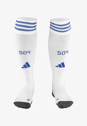 Weiße Sportsocken mit blauen Streifen und dem Text "S04". Verfügt über verstärkte schwarze Zehen- und Fersenbereiche mit einem strukturierten Muster.