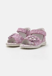Lilla mønstrede sandaler med åbne tå, med ankelstropper, blomsterdetaljer og polka-dots indersåler. Gummisåler for godt greb.