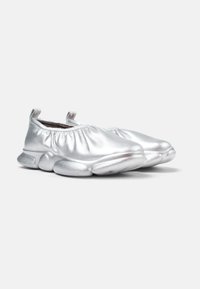 Silver metallic slip-on shoes with gathered upper design, rounded toe, and cushioned, bulbous sole. Smooth texture with subtle shine.