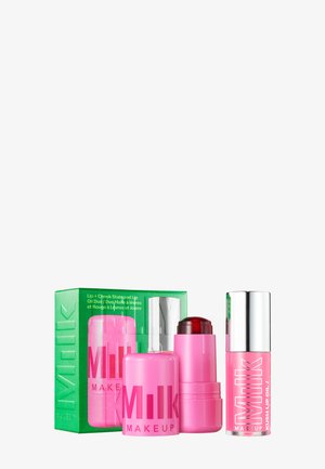 Milk Makeup gift set includes three pink products: a lip oil, a lip and cheek stain, and a cream stick, all in sleek packaging with green accents.