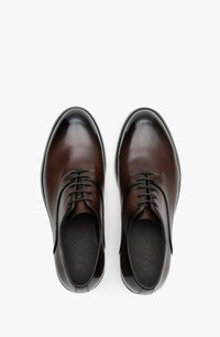 Brown leather dress shoes with a sleek design, round toe, and six-eyelet lacing. Smooth texture with subtle shine and low-profile sole.