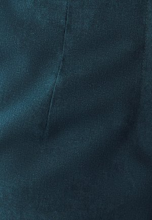 Sinine tekstureeritud kangas sileda viimistlusega; omad nähtavad õmbluse detailid ilma kaunistuste või mustriteta.