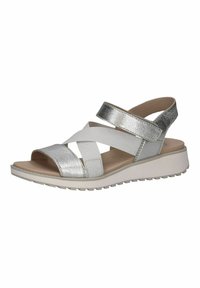 Stříbrné metalické sandály s křížovým popruhem, elastickým páskem, otevřenou špičkou a polstrovanou bílou podešví. Texturovaný materiál a nízký podpatek.