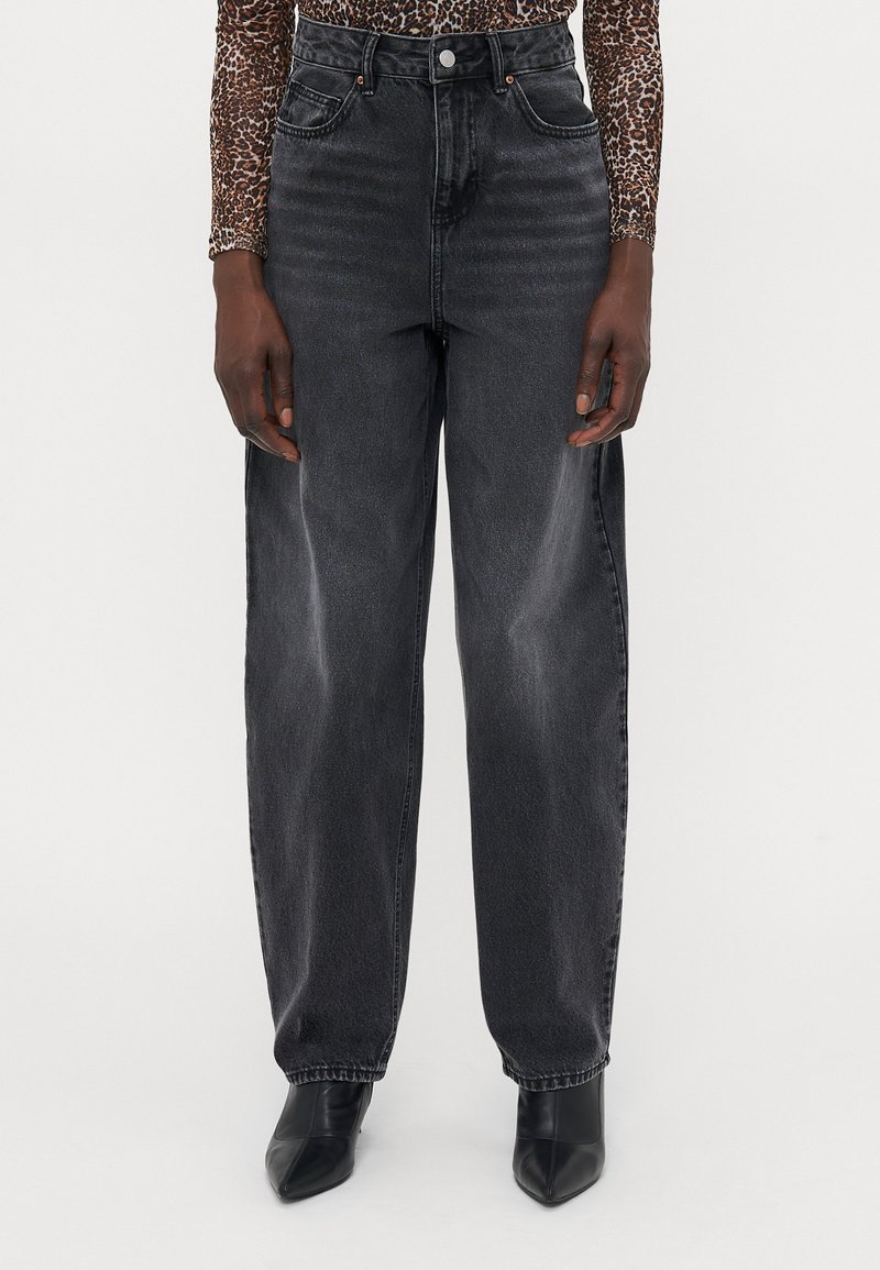 High-waisted black denim jeans with a loose fit, subtle fading, front pockets, and stitched detailing at the waistband and hem.