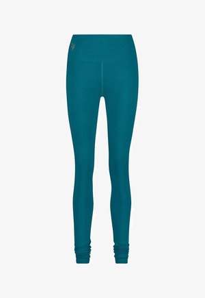 Türkisblaue Leggings mit figurbetontem Design, gefertigt aus weichem, elastischem Stoff. Verfügt über einen breiten Bund und geraffte Details am Knöchel.