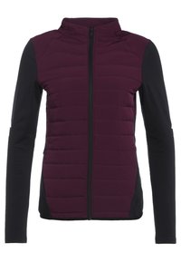 Giacca da donna con parte anteriore trapuntata di colore viola scuro, maniche nere, chiusura con zip completa e colletto alto.