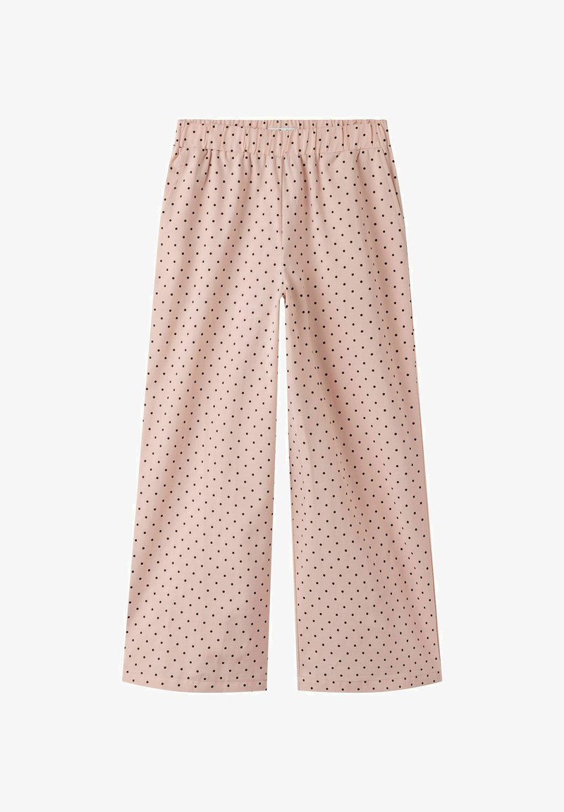 Pantalon ample rose clair à pois noirs avec une taille élastiquée, posé à plat sur un fond blanc.