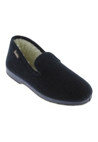 Zapatilla de lana negra con un interior suave, puntera redonda y suela de goma plana. Presenta una pequeña etiqueta de marca en el costado.