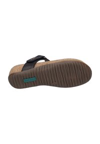 Black strap sandal with a cork footbed and rubber outsole. Features embossed logo and textured bottom for grip. Accented with turquoise branding.
