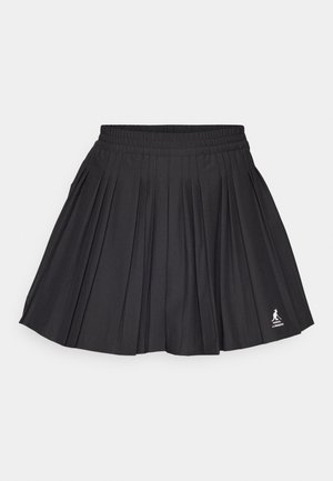Black pleated skirt with an elastic waistband, featuring a logo at the bottom right corner, set against a white background.