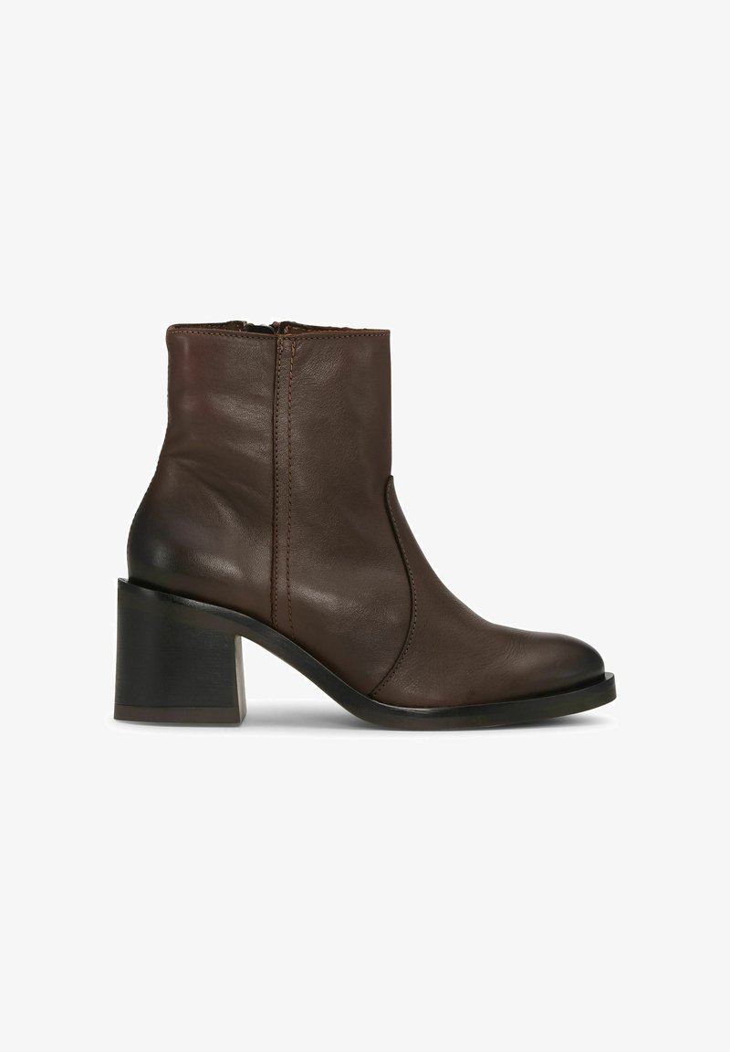 Brown leather ankle boot with a block heel, featuring a side zipper and smooth texture. Rounded toe and subtle stitching details.