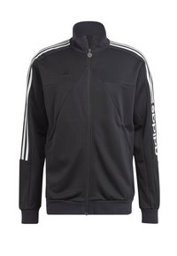 Chaqueta deportiva negra fabricada en tejido, con un alto cuello, cierre completo y bolsillos laterales. Presenta rayas blancas y un logo en las mangas.