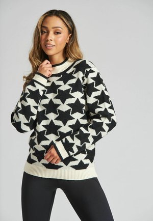 Schwarzer und weißer Pullover mit Sternenmuster aus weichem Strick, mit Rundhalsausschnitt, gerippten Bündchen und lockerer Passform.