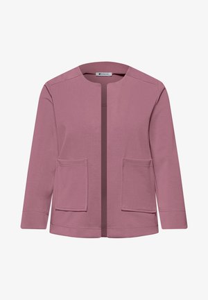 Lilla jakke med åben forside, lange ærmer og to forlommer med lapper, der har en rund halsudskæring og enkle syningsdetaljer.
