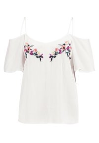 Bílý top s odhalenými rameny a tenkými ramínky, zdobený květinovou výšivkou v růžové, fialové a žluté barvě na hrudníku. Texturovaná látka.