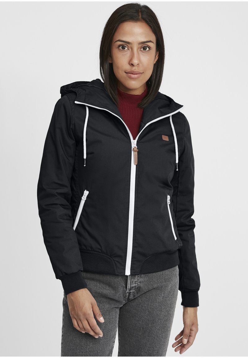 Black jacket with a hood, white zipper, elastic cuffs, and side pockets. Features a logo patch and ribbed waistband.
