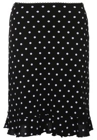 Jupe noire à pois blancs avec un ourlet à volants, présentant une bordure subtile en dentelle à la taille.