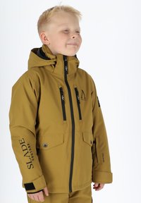 Braune wasserdichte Jacke mit schwarzen Reißverschlüssen und Akzenten, ausgestattet mit zwei Fronttaschen, einem hohen Kragen und elastischen Bündchen für zusätzliche Wärme.