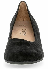 Black suede high-heeled shoe with a pointed toe and a slight cutout design. The interior features a beige lining with branding.