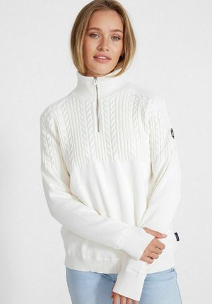 White knitted sweater featuring a high collar, half zip closure, cable knit pattern on the upper portion, and ribbed cuffs and hem.