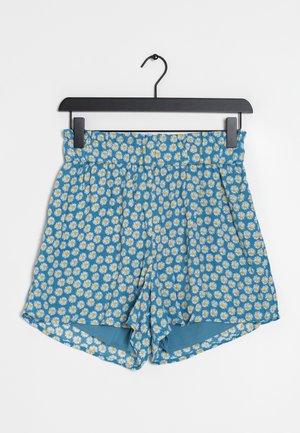 Blå shorts med blommönster av vita prästkragar med gula centrum. Elastisk midjeresår med veck, avslappnad passform och sidsömmar.