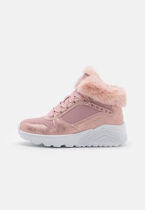 Roze hoge sneaker met metalen accenten, pluizige bontkraag, veterluiting aan de voorkant en dikke witte gestructureerde zool, zijaanzicht.