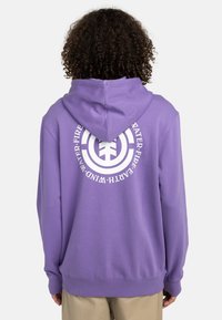 Purple hoodie made from soft fabric, featuring a white circular logo and text on the back, front kangaroo pocket, and drawstring hood.