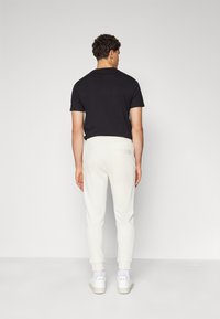 HUGO DOAK - Tracksuit bottoms - open white