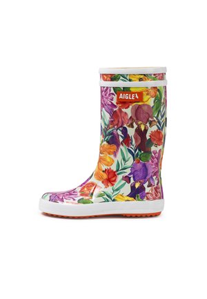 Children's white rubber rain boot with multicolored floral pattern, white sole, and orange "AIGLE" logo on the front.