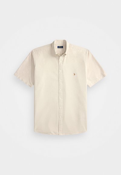 Short-sleeve button-up shirt in light beige cotton, featuring a classic collar and small embroidered logo on the chest.