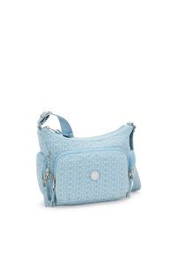 Light blue crossbody bag made of textured fabric, featuring a geometric pattern, zip pockets, and a decorative tassel detail.