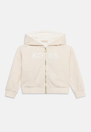 Lysebeige hættetrøje med lynlås og diskret gentaget mønster, foran lynlås med cirkulært logotræk, og stor hætte.