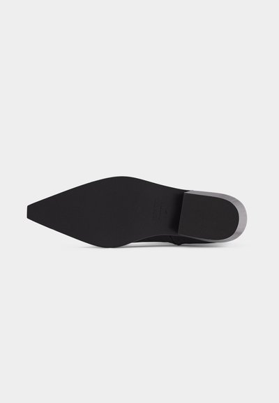 Black pointed-toe shoe sole with squared heel and smooth, flat surface shown against a plain light background.