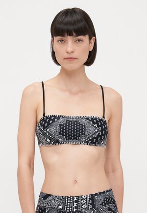 Black bandeau bikini top with thin straps, featuring white paisley patterns and a textured finish. Smooth fabric with contrasting accents.