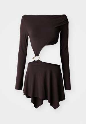 Black long-sleeve top with asymmetrical hem, featuring a twist design and circular gold hardware detail at the waist. Soft, stretchy material.