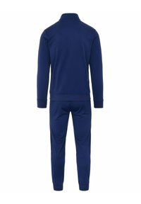 Tuta blu navy con giacca con zip e colletto alto, maniche lunghe e pantaloni coordinati con polsini a coste. Tessuto morbido al tatto.