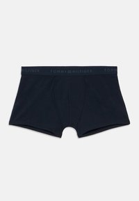 Navy blue cotton boxer briefs with a dark blue elastic waistband featuring "TOMMY HILFIGER" embossed around it, offering a snug fit.