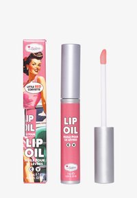 Olej do ust w różowej tubie z metalową nakrętką i aplikatorem. Opakowanie zdobione retro ilustracją. Tekst zawiera "OLEJ DO UST" i "MAŁY CZERWONY KORWETTE."