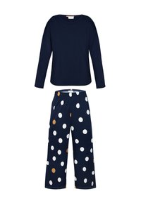 Granatowa bluzka z długim rękawem noszona z granatowymi spodniami w białe i beżowe kropki; miękki materiał, casualowy fason, luźny krój i elastyczny pasek w talii.