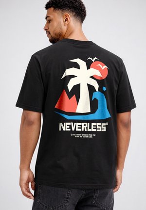Man wearing a black T-shirt with a graphic of a palm tree, red sun, blue wave, red mountains, and the text "NEVERLESS" on the back.