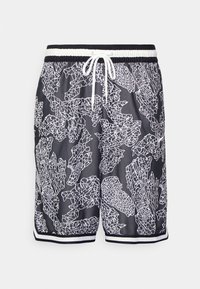Shorts de bain noirs avec des motifs abstraits en forme de corail blancs, taille élastique, cordon de serrage et rayures blanches contrastantes à l'ourlet.