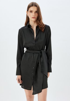 Schwarzes Satin-Hemdkleid mit langen Ärmeln, Knopfleiste und gebundenem Taillengürtel. Verfügt über einen leicht geschlitzten Saum und eine glatte Textur.