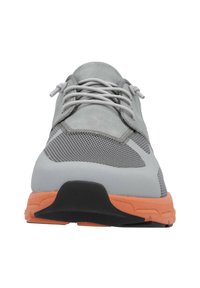 Gray athletic shoe with a mesh upper, synthetic accents, and an orange outsole. Features a rounded toe and textured midsole for cushioning.
